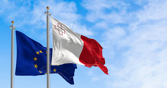 The flags of Malta and the European Union waving in the wind on a clear day. Luxembourg became a member of the EU in may 2004. 3d illustration render. Fluttering textile
