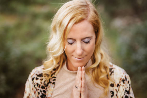 istock Beautiful woman praying with close eys and a grateful face gesture 1483309314