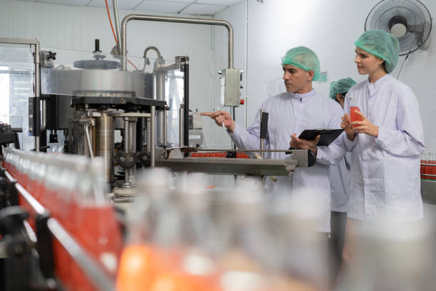 istock A quality supervisor or food or beverages technician discuss about process control of food and drugs before send product to the customer. Production leader recheck ingredient and productivity. 1483311268