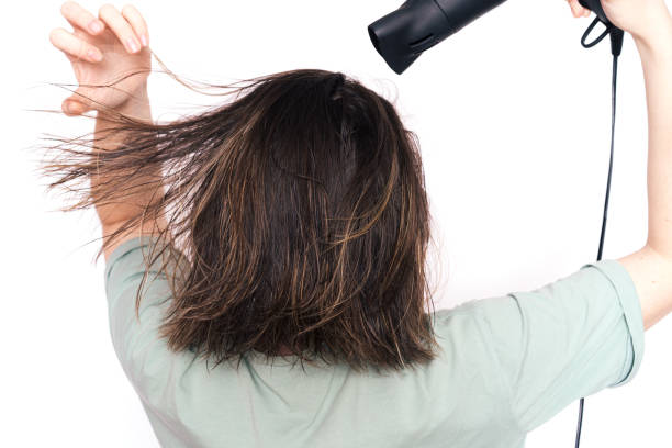istock Lady drying her hair against white background 1483312282