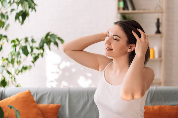 istock Lady sitting on the couch gives herself a head massage 1483312307