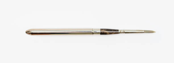 istock Metal watercolor paint brushes on white background. Pointed brushes. Close up. 1483312866