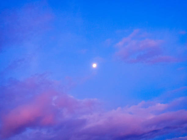 istock The moon shines amidst the vast blue sky 1483313957