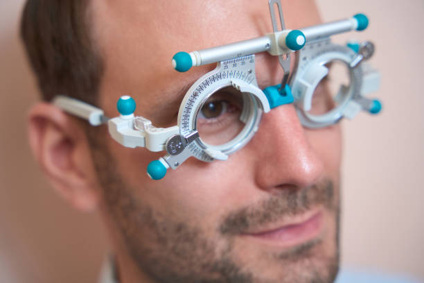 istock Man is examining his visual acuity with special lenses in ophthalmology center 1483314283