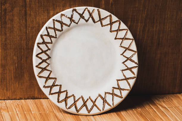 istock Clay plate with painting on bamboo mat. 1483315554