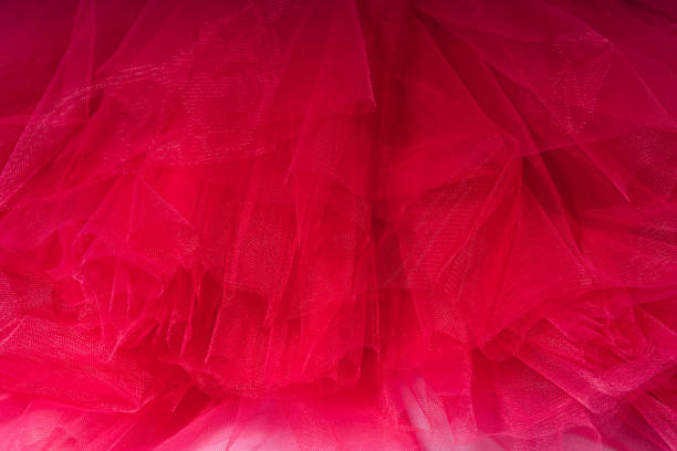 istock Red background of tulle fabric close-up 1483317591