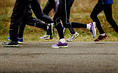 legs group runners men and women in leggings run spring race on asphalt road