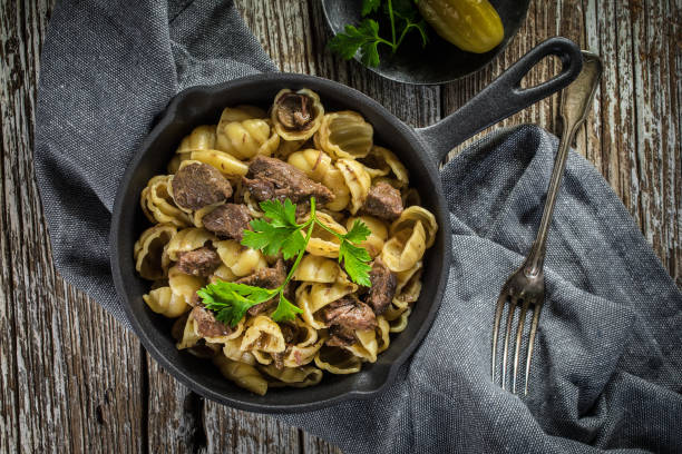 istock Italian pasta shells with beef sauce in cast iron pan. 1483321109