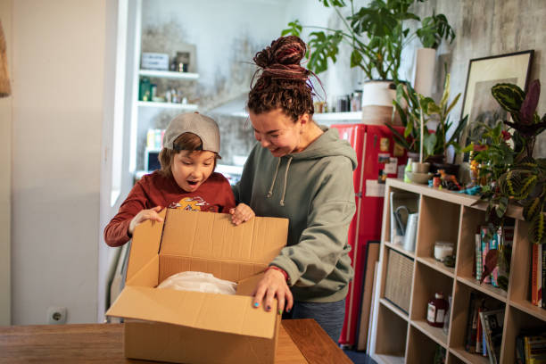 istock Mother and son opening up a box they received in the mail 1483321236