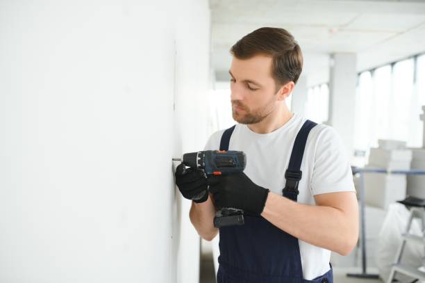 istock drywall worker works on building site in a house. 1483322577