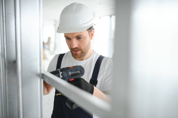 istock man fasten metal profile frame to the wall for draywall bulkhead 1483322762