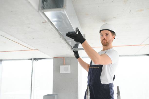 istock Industrial Theme. Warehouse Heating and Cooling System Installation by Professional Caucasian Technician. Commercial Building Ventilation Rectangle Canals. Air Distribution. 1483322845