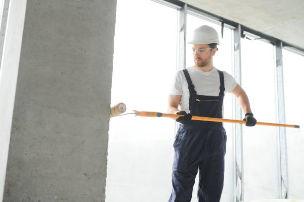 istock Worker renewing apartment on wall background. 1483322918