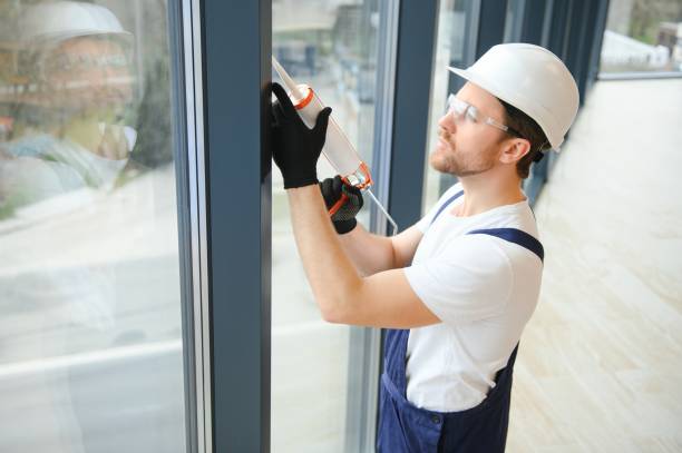 istock handsome young man installing bay window in new house construction site. 1483324560
