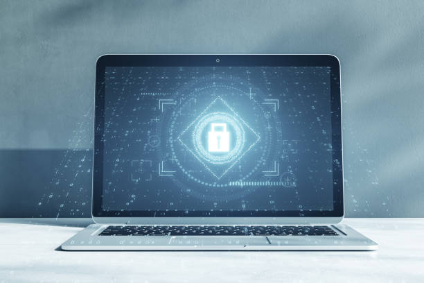 istock Close up of laptop with glowing padlock interface on concrete wall background. Safety, security and protection concept. 3D Rendering. 1483324708