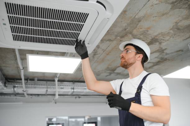 istock handsome young man electrician installing air conditioning. 1483324730