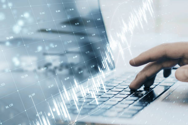 istock Close up of hands using laptop keyboard with glowing candlestick forex chart and index grid on blurry office background. Trade, finance and market data concept. Double exposure. 1483324828
