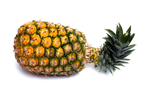 Male human hand holding a pineapple