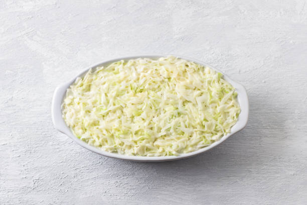 istock Raw cabbage casserole in a baking dish on a light gray background, top view. Stage of cooking healthy vegan food 1483326672