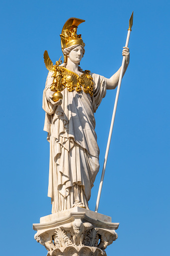 Pallas Athene statue unveiled in 1902 on Vienna Ring Road. Classical Greek goddess of wisdom and warfare wearing gilded helmet and chest armor holding gilded figure of goddess of victory Nike by Austrian sculptor Carl Kundmann (1838-1919)