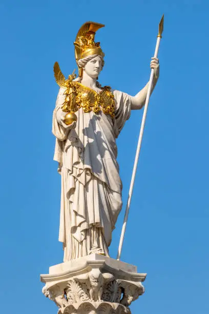 Pallas Athene statue unveiled in 1902 on Vienna Ring Road. Classical Greek goddess of wisdom and warfare wearing gilded helmet and chest armor holding gilded figure of goddess of victory Nike by Austrian sculptor Carl Kundmann (1838-1919)