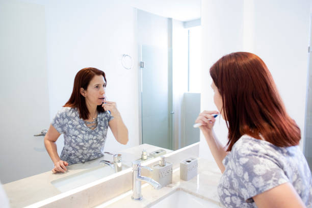 istock Woman brushing her teeth 1483327179