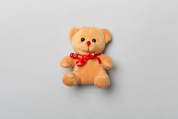 istock Cute teddy bear on color background, top view 1483327520