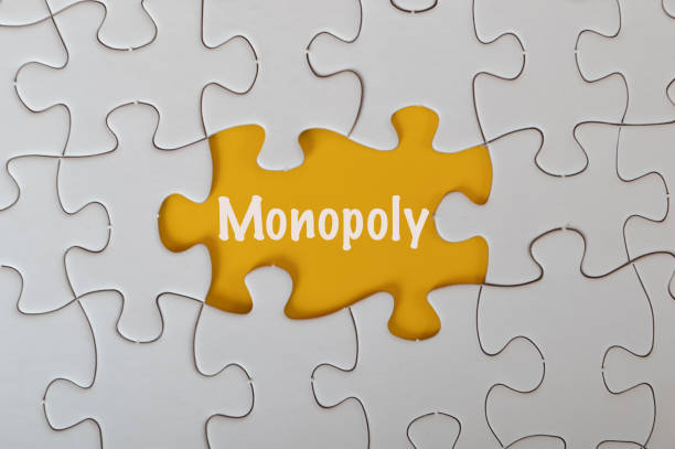 istock Missing jigsaw puzzle with text MONOPOLY isolated on a yellow background. 1483328865