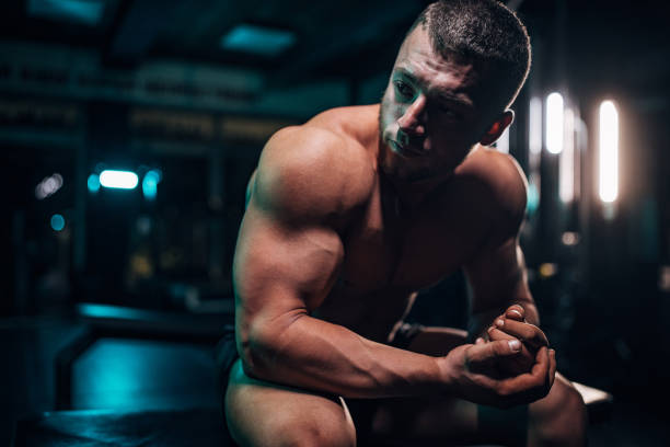 istock Male body builder sitting in gym 1483328973