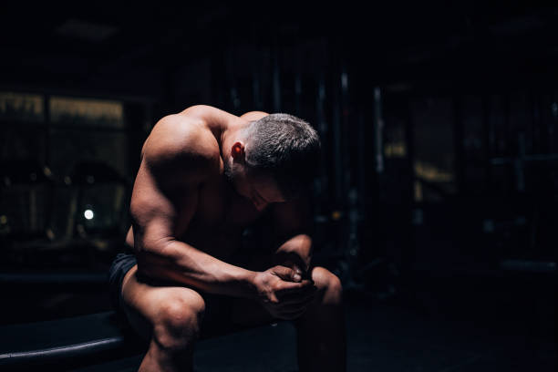 istock Male body builder sitting in gym 1483329043