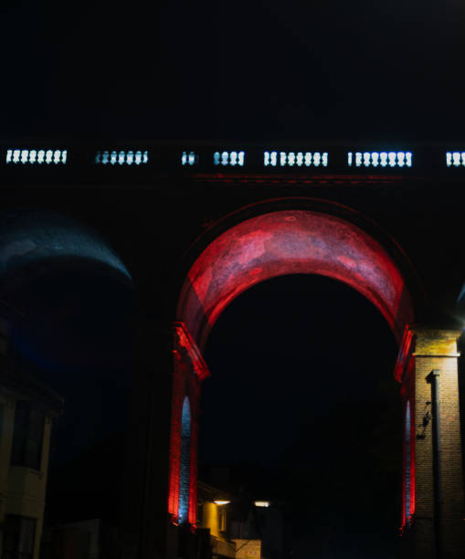 istock Image of train crossing over bridge colourfully lit up. 1483330134
