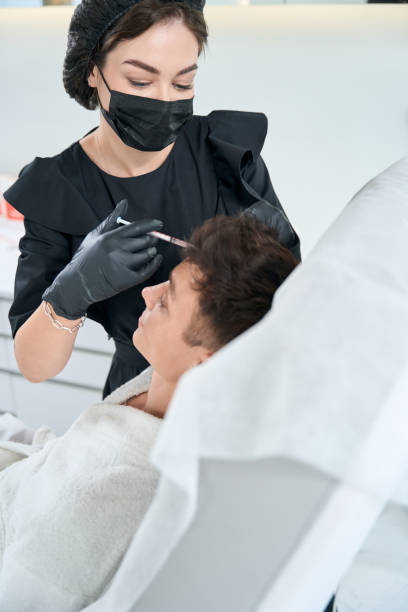 istock Man in beauty clinic getting hair injection procedures 1483330705