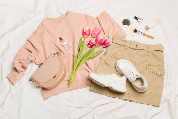 istock Stylish pastel spring outfit on white sheet background, top view 1483331577