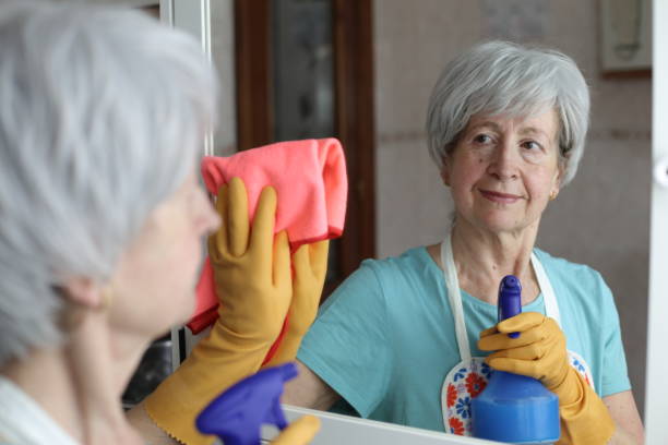 istock Senior woman cleaning a mirror 1483333269