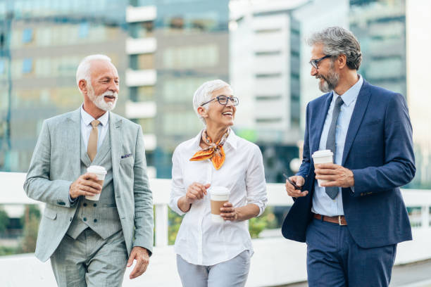 istock Three mature business people walking outdoors 1483343475