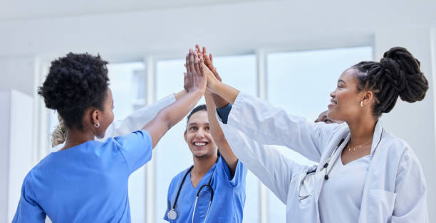 istock Success, high five and teamwork with doctors in hospital cheering for celebration, support or goal. Medical, healthcare and medicine with group of people and gesture for achievement, target or winner 1483347933