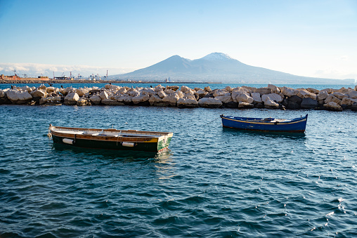 Vesuvius seen and fish boats from the seafront of Naples, Italy