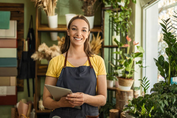 istock Owner at her flowers shop looking at camera 1483352125