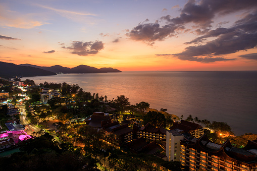 Aerial dusk sunset view of luxury hotels on Batu Ferringhi beach located in Penang, Malaysia.