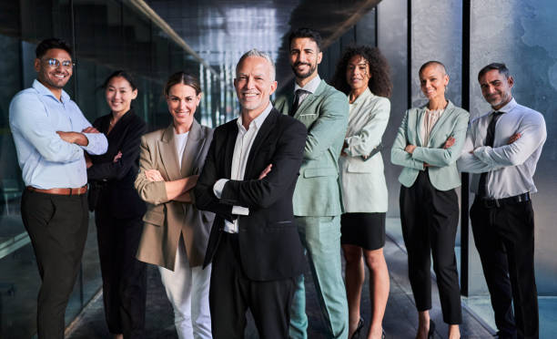 istock Multicultural business team headed by boss. Posing to camera cheerfully at the office. 1483352742