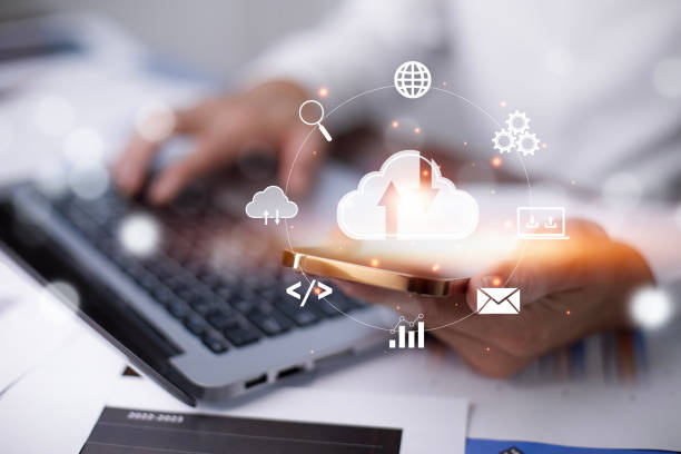 istock Businessman hand holding smartphone and laptop with cloud computing diagram show on hand. Cloud technology. Data storage. Networking and internet service concept, Cloud sharing download and upload 1483355262