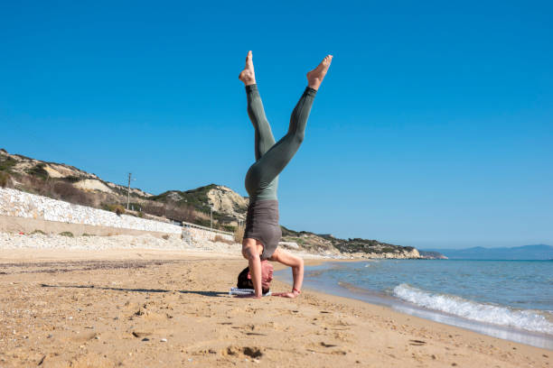 istock Woman practising yoga on the beach 1483355278