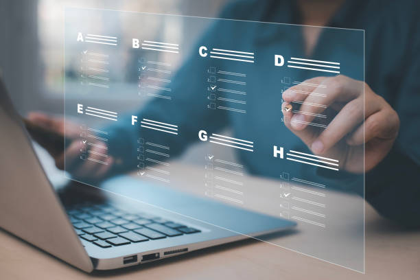 istock Businessman using a laptop and Taking an assessment, questionnaire, evaluation, online survey online exam Choosing the right answer in exam by filling out the online survey form,Answer  test questions 1483355290