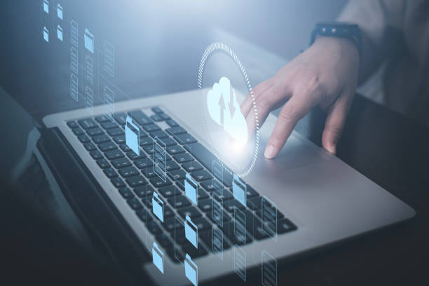 istock Businessman hand holding smartphone and laptop with cloud computing diagram show on hand. Cloud technology. Data storage. Networking and internet service concept, Cloud sharing download and upload 1483355316