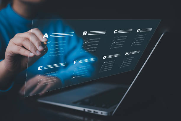 istock Businessman using a laptop and Taking an assessment, questionnaire, evaluation, online survey online exam Choosing the right answer in exam by filling out the online survey form,Answer  test questions 1483355704