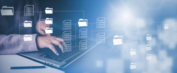 istock Businessman working on laptop with virtual screen. Online documentation database, IT consultant being set up Virtual Document Management System with laptop,Software for archiving corporate files. 1483357259