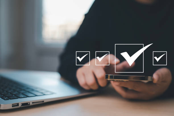 istock Businessman hold Smartphone with Taking assessment, questionnaire, evaluation, online survey online exam Choosing the right answer in exam by filling out the online survey form,Answer  test questions 1483358023