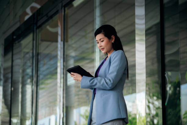istock Businesswoman sale manager using mobile phone while walking at business district 1483358458