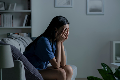 Sad woman feeling negative emotions alone at home