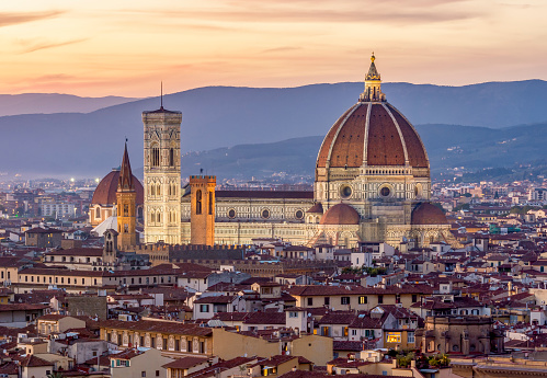 Italian town Florence (Firenze) by dusk, Florence Cathedral in the middle, Apennine mountains on the background